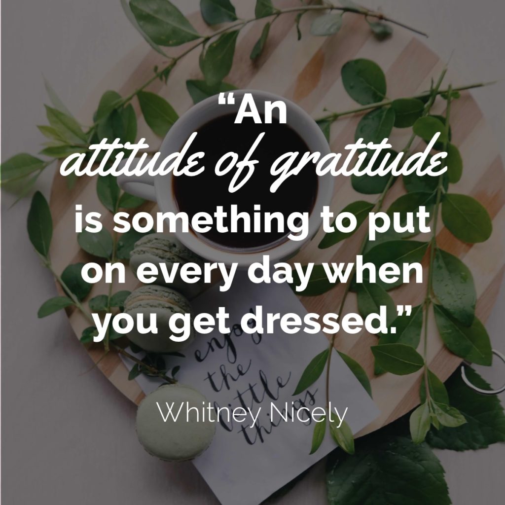Leaves on wood board with tea and macaroons, quote "An attitude of gratitude is something to put on every day when you get dressed." ~ Whitney Nicely