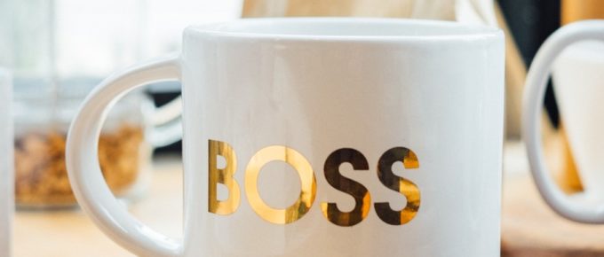 header image of white coffee mug with label "Boss" in gold letters